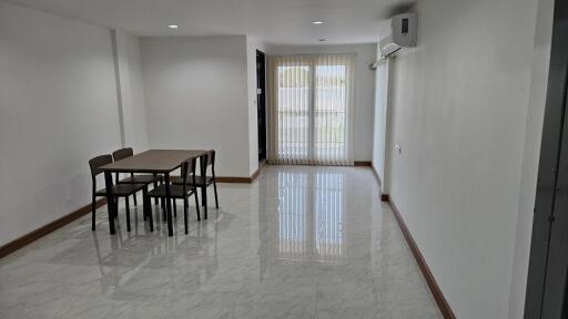 Minimalist dining area with table and four chairs