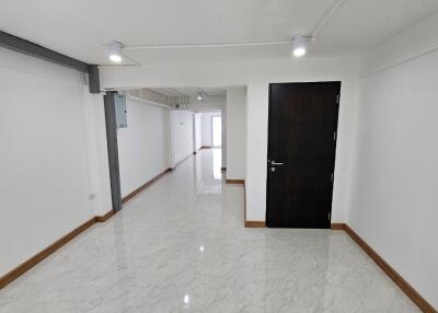 Spacious hallway with tiled floor and modern lighting