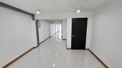 Spacious hallway with tiled floor and modern lighting