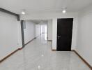 Spacious hallway with tiled floor and modern lighting