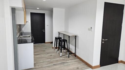 Minimalist kitchen with small bar area