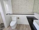 Modern bathroom with white brick wall and sleek fixtures