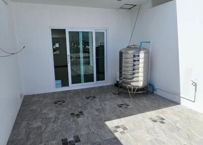 Rooftop area with water tank and glass doors