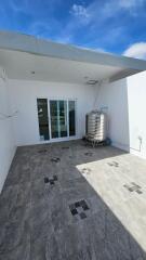 Rooftop area with water tank and glass doors