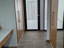 Hallway with wooden flooring and built-in wooden closets