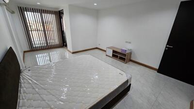 spacious bedroom with large window