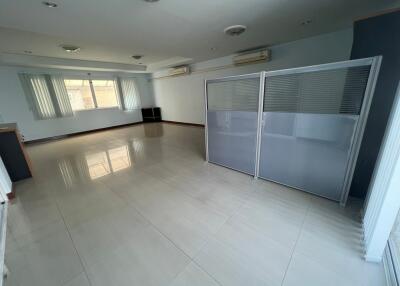 Spacious living room with tiled floor and natural lighting