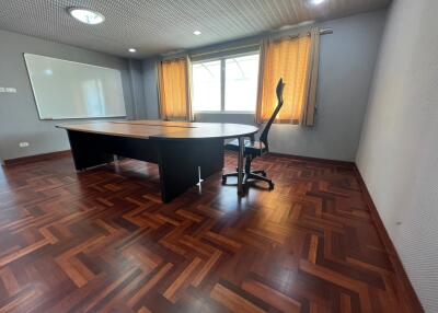 Office room with parquet flooring and large window