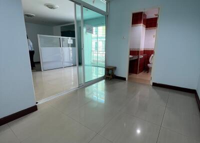 Living area with tile flooring next to the kitchen and bathroom