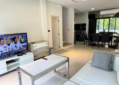 Modern living room with open kitchen and dining area