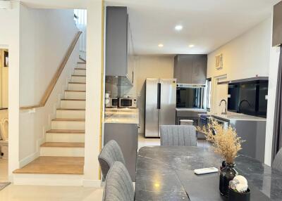 Modern kitchen with stainless steel appliances and dining area