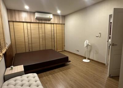 View of a bedroom with wooden flooring and blinds