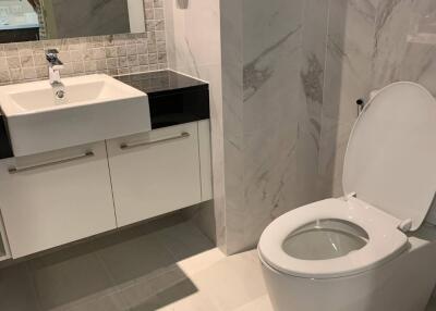 Modern bathroom with sink, vanity, and toilet