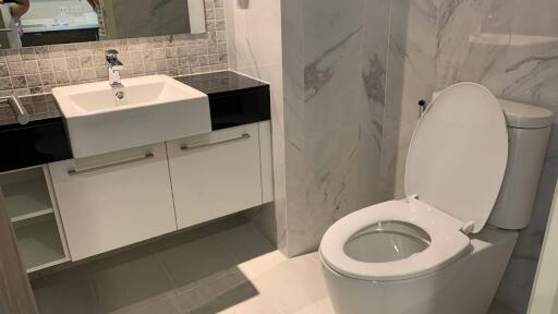 Modern bathroom with sink, vanity, and toilet