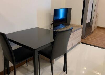 Modern living area with dining table and TV