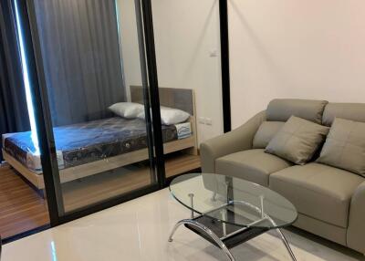 Living room with glass partition to bedroom