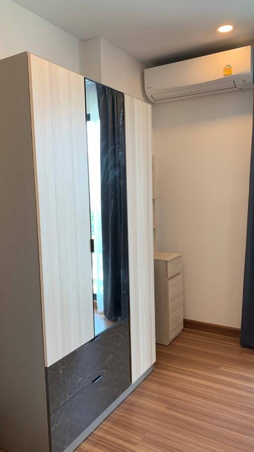 Bedroom with modern wardrobe and air conditioning unit