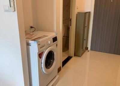 Laundry area with washing machine and storage closet