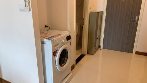 Laundry area with washing machine and storage closet