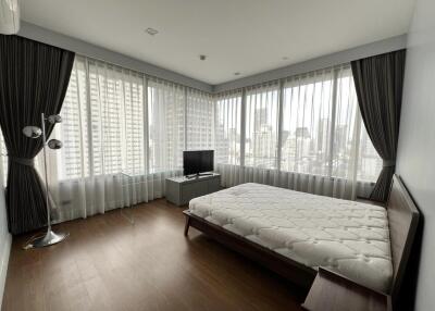 Modern bedroom with large windows and city view