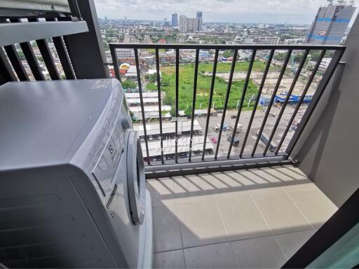 Balcony with washing machine and city view