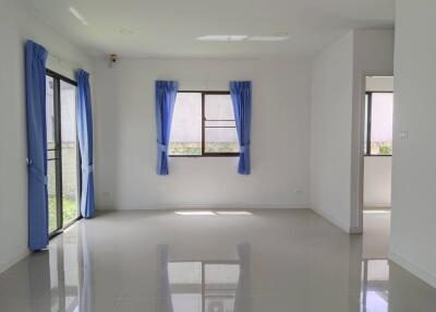 Spacious living room with large windows and blue curtains