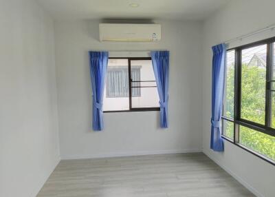 Bedroom with windows and blue curtains