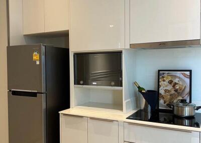 Modern kitchen with white cabinets and stainless steel appliances