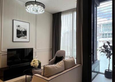 Modern living room with chandelier and large window