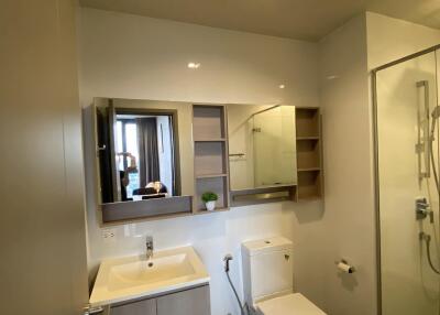 Modern bathroom with sink, toilet, and shower