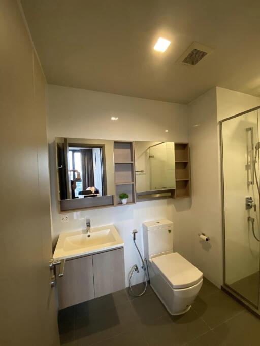 Modern bathroom with sink, toilet, and shower