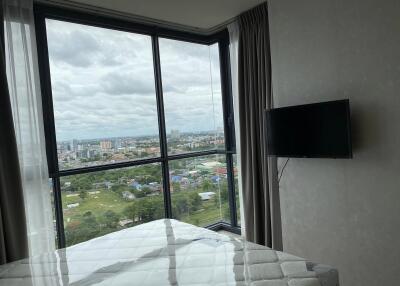 Bedroom with large windows and city view