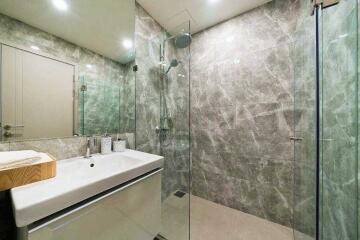 Modern bathroom with glass shower and marble tiles