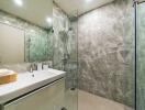 Modern bathroom with glass shower and marble tiles