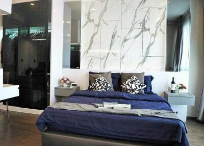 Modern bedroom with marble accent wall