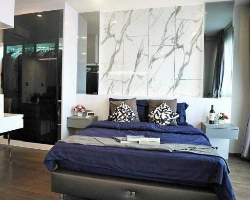 Modern bedroom with marble accent wall