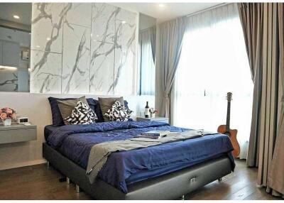 Modern bedroom with blue bedding and natural light
