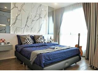 Modern bedroom with blue bedding and natural light