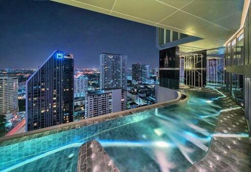 Rooftop infinity pool with cityscape view at night