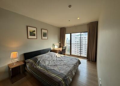 Bright bedroom with large window and balcony