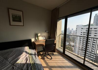 Cozy bedroom with desk and city view