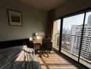 Cozy bedroom with desk and city view