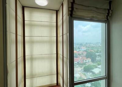 Balcony with large window and city view