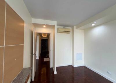 Living room with hardwood floors and open hallway