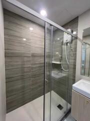 Modern bathroom with glass shower enclosure and vanity unit