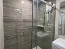 Modern bathroom with glass shower enclosure and vanity unit