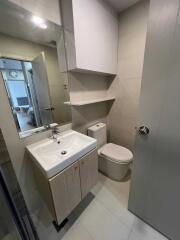 Modern bathroom with white fixtures and storage