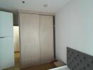 Minimalist bedroom with a sliding door wardrobe