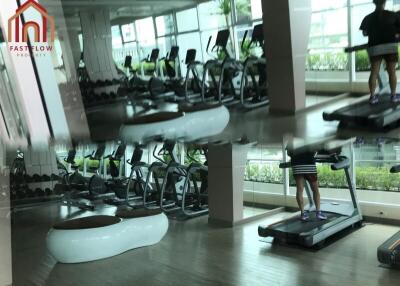 Well-equipped gym with various machines and green view