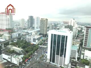 Aerial view of cityscape with skyscrapers and main road